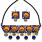 A matching jewelry set featuring a braided black neck strap, a navy blue patterned choker necklace, and a pair of square drop earrings, all decorated with colorful circular motifs in orange, red, yellow, and blue with silver-toned dangling charms.