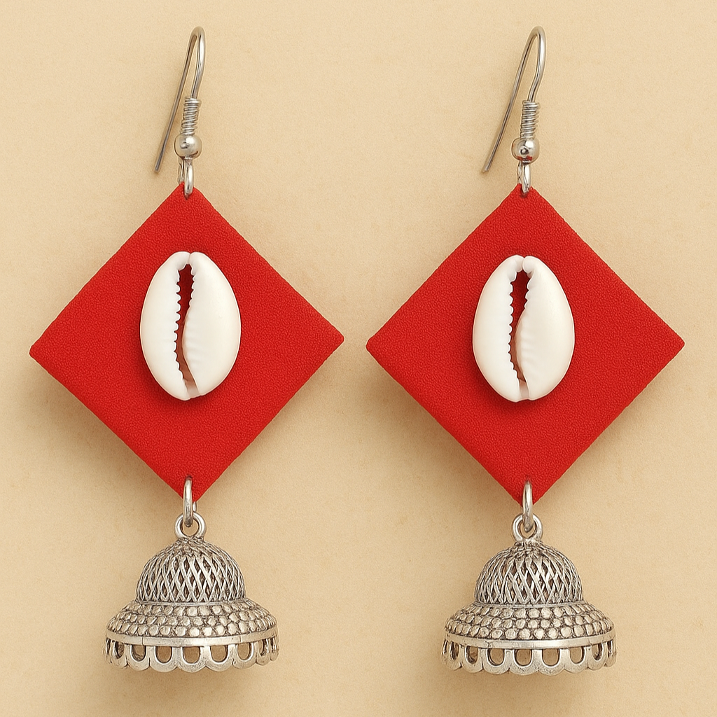 Fabric Earrings with red geometric pendants, cowrie shells, and silver jhumkas on a beige background